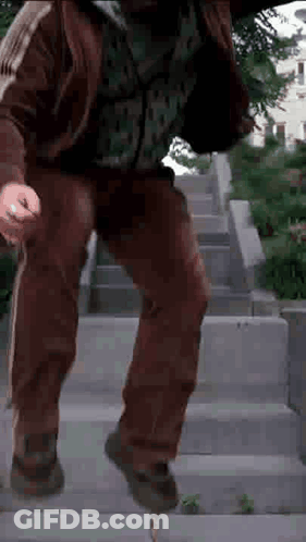 Man In Brown Jacket Walking Down Stairs GIF