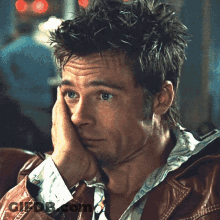Man In Brown Leather Jacket Hand On Face GIF