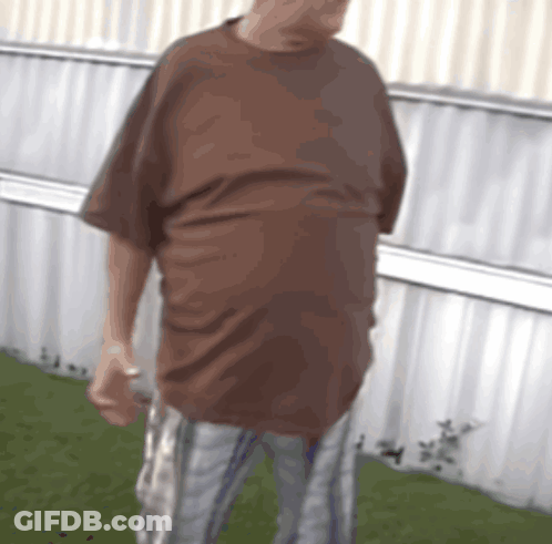 Man In Brown Shirt And Plaid Shorts GIF