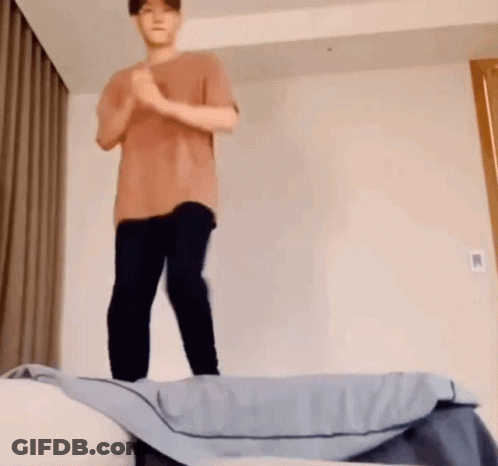 Man In Brown Shirt Jumping Off Bed GIF
