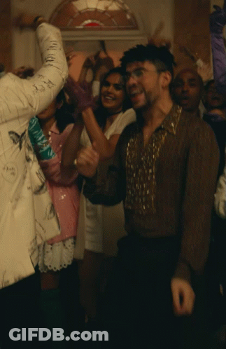 Man In Brown Shirt Surrounded By People GIF