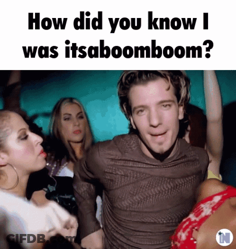Man In Brown Shirt Surrounded By Women Saying How Did You Know I Was Itsaboomboom GIF