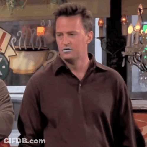 Man In Brown Shirt With Coffee At Window GIF