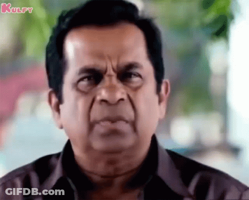 Man In Brown Shirt With Serious Look GIF