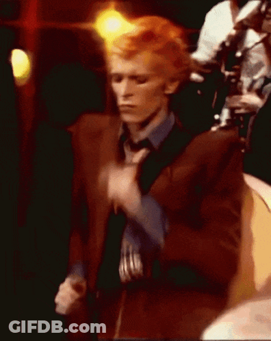 Man In Brown Suit And Blue Shirt Dancing GIF