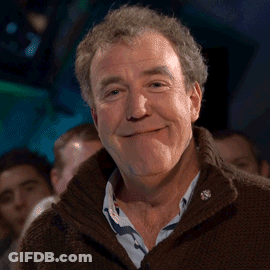 Man In Brown Sweater And Blue Shirt Smiling GIF