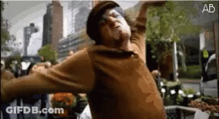 Man In Brown Sweater Hat Dancing Before Crowd GIF
