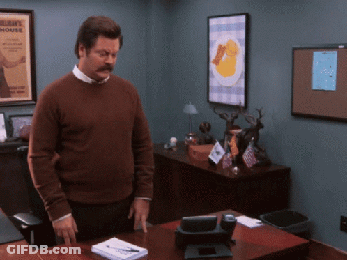 Man In Brown Sweater In Front Of Bulletin Board Saying William's House GIF