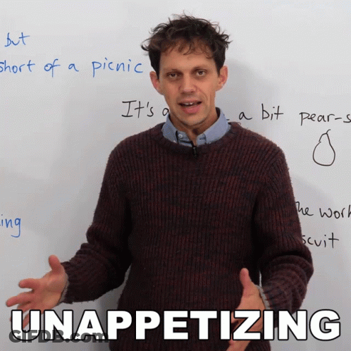 Man In Brown Sweater In Front Of White Board With Unappetizing GIF