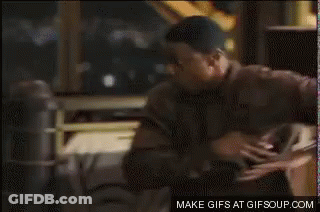 Man In Brown Sweater Looking At Cell Phone GIF