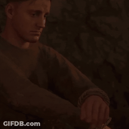 Man In Brown Sweater Sitting In Dark Room Checking Watch GIF