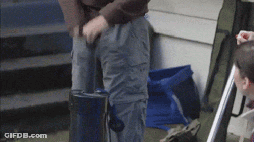 Man In Brown Sweater Standing On Stairs GIF