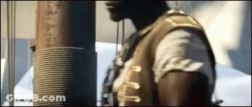 Man In Brown Vest Standing GIF