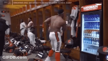 Man In Browns Uniform Standing Next To Gatorade Cooler GIF