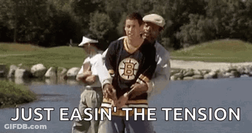 Man In Bruins Jersey Helped By Man In Golf Shirt GIF