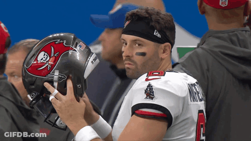 Man In Buccaneers Jersey Holding Helmet GIF