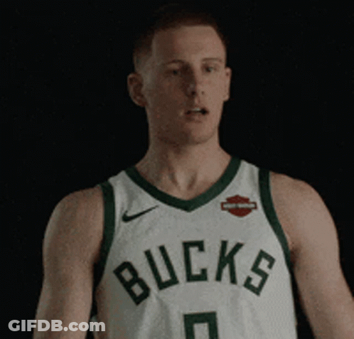 Man In Bucks Jersey Standing In Dark GIF
