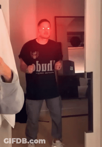 Man In Bud T-Shirt Standing In Room GIF