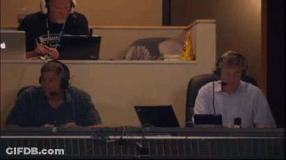 Man In Budweiser Shirt With Headphones At Desk GIF