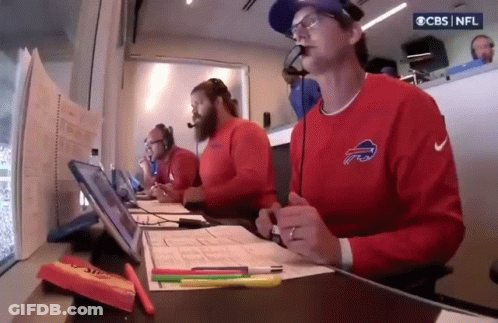 Man In Buffalo Bills Sweatshirt At Desk With Microphone GIF