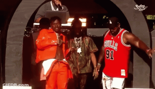 Man In Bulls 91 Jersey With Two Others On Stage GIF