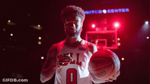 Man In Bulls Jersey Holding Wilson Basketball GIF