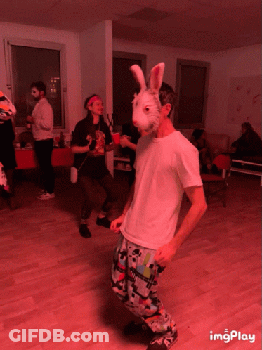Man In Bunny Mask Dancing In Red Room GIF