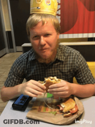 Man In Burger King Crown Eating Hamburger GIF