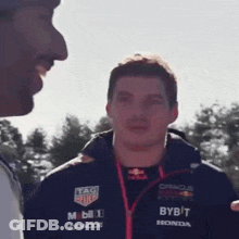 Man In Bybit Jacket Talking To Another Man GIF