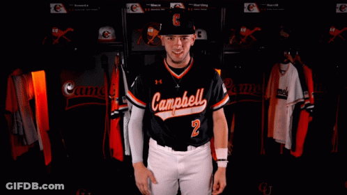 Man In Camel Jersey Arms Crossed In Locker Room GIF