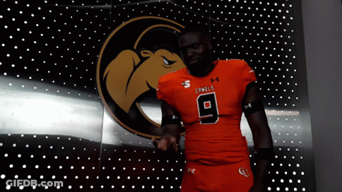 Man In Camel Jersey In Front Of Lights GIF