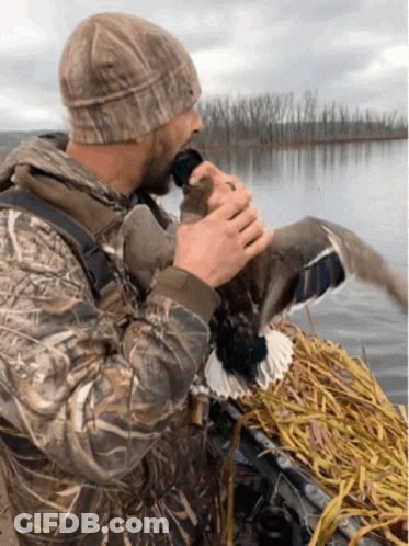 Man In Camo Jacket Holding Duck GIF