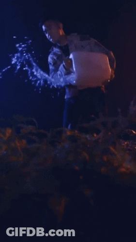 Man In Camo Jacket Holding Torch GIF
