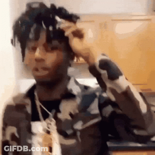 Man In Camouflage Jacket In Kitchen GIF