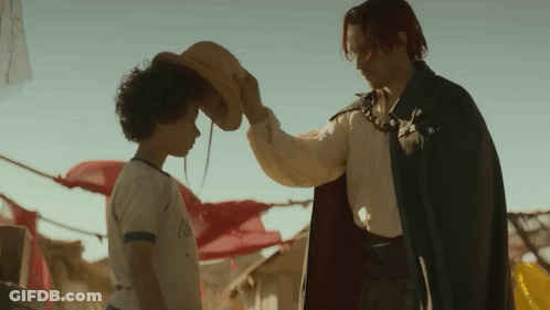 Man In Cape Holding Cowboy Hat Over Child GIF