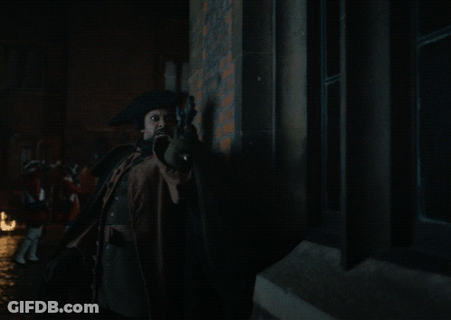 Man In Cape Holding Torch With Flames GIF