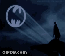 Man In Cape In Front Of Batman Logo GIF