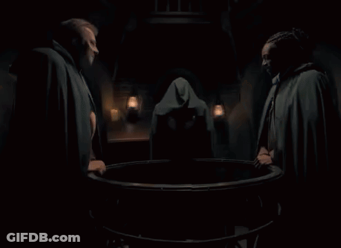 Man In Cape Laughing In Dark Room With Lanterns GIF