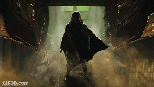 Man In Cape Standing In Dark Hallway GIF