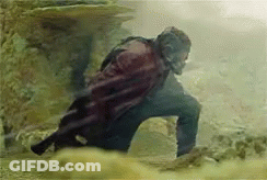 Man In Cape Standing In Dirt Field GIF