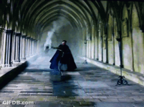 Man In Cape Walking Down Hallway GIF