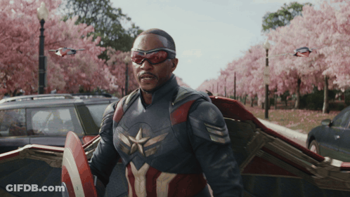 Man In Captain America Costume In Front Of Car GIF