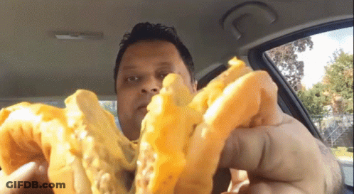 Man In Car Eating French Fries With Bite Taken Out GIF
