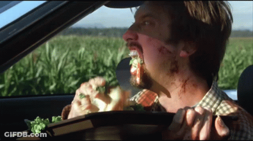 Man In Car Eating Sandwich With Field GIF