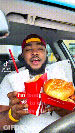 Man In Car Holding Hamburger And Drink GIF