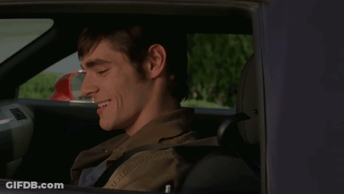 Man In Car Smiling With Red Mirror GIF