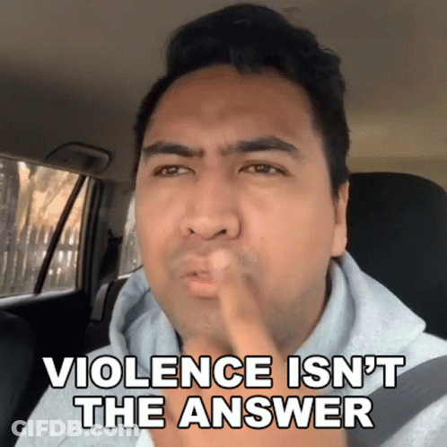 Man In Car With Finger In Mouth Saying Violence Isn't The Answer GIF