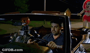 Man In Car With Sign Saying I Will Chase You Down GIF