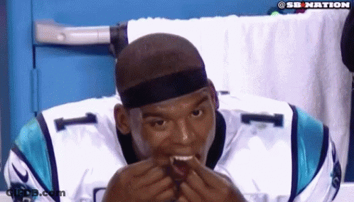 Man In Carolina Panthers Jersey Eating Hamburger GIF