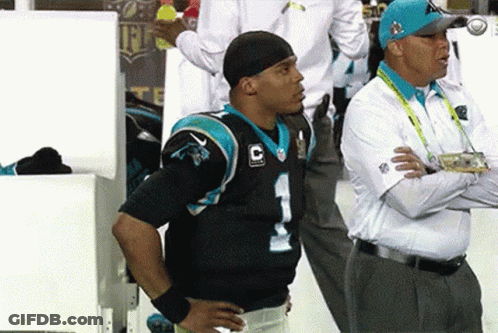Man In Carolina Panthers Jersey Next To Man In White Shirt GIF